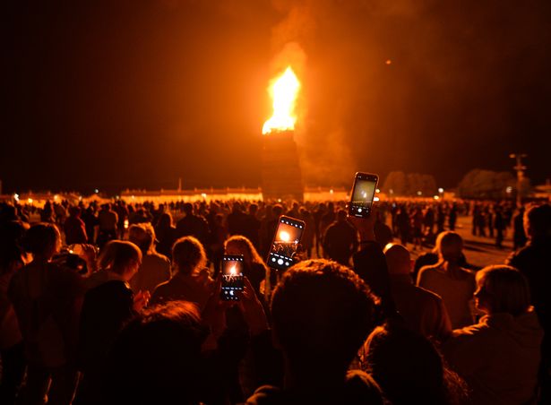 Spectators flee as huge bonfire collapses